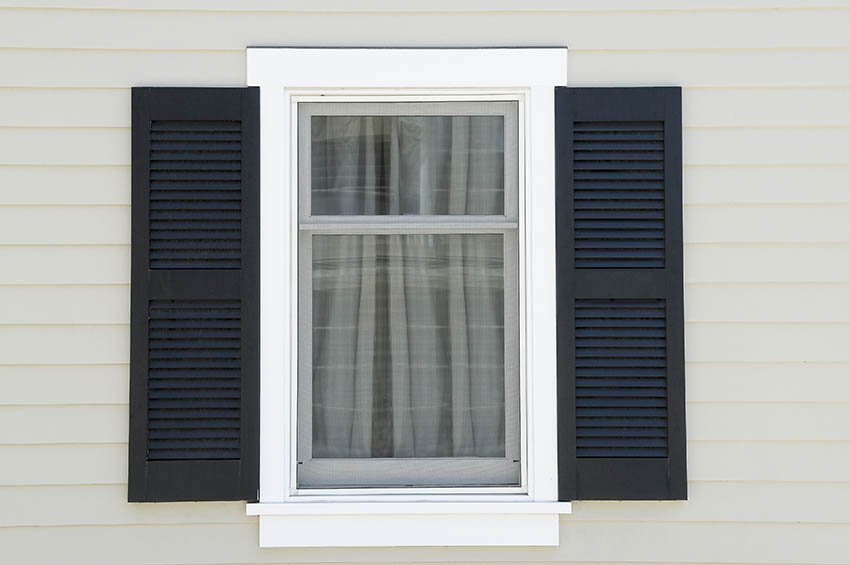 Cape Cod style beach house with double hung window and shutters.